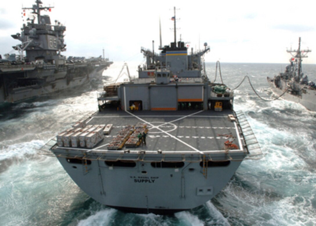 The fast combat support ship USNS Supply (T-AOE 6) pumps fuel to the guided-missile frigate USS Taylor (FFG 50) (right) and the aircraft carrier USS Enterprise (CVN 65) as the ships steam in formation in the Atlantic Ocean on March 3, 2006. 