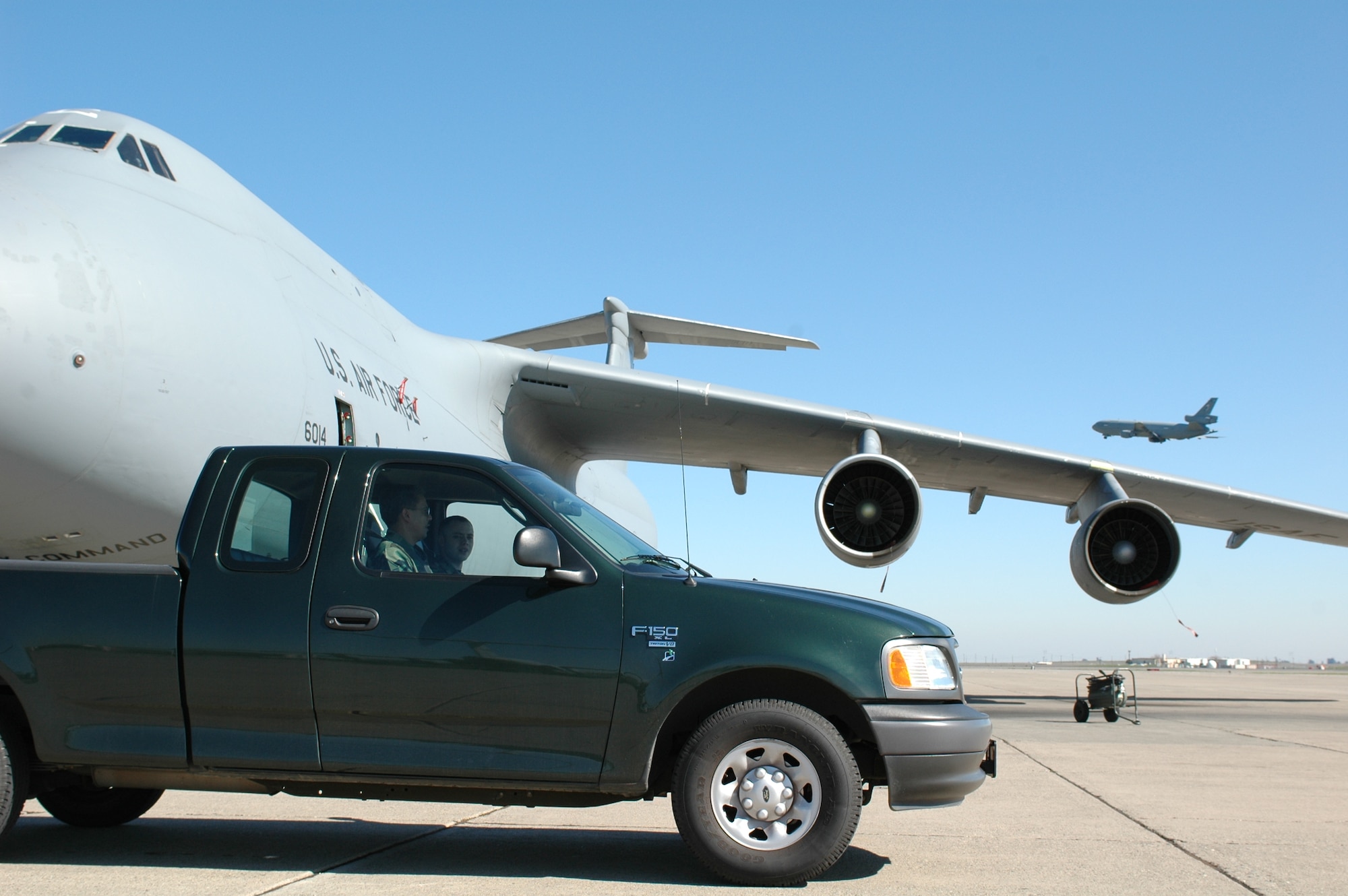 Members of the 60th Aircraft Maintenance Squadron park at the safe distance from a C-5. Vehicle parking rules are intended to provide clear areas for aircraft operations.  Parking with the driver’s door toward the aircraft establishes a traffic pattern for vehicle flow. (U.S. Air Force photo by Staff Sgt. Matt McGovern)