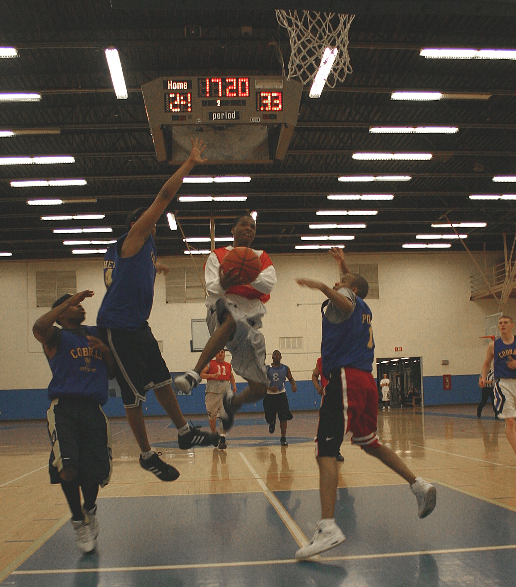 CANNON AIR FORCE BASE, N.M. -- Early in the second half, SFS’ Rashaud Blair flies past three CMS players to give his team an 11-point lead. (U.S. Air Force photo by Airman Thomas Trower)
