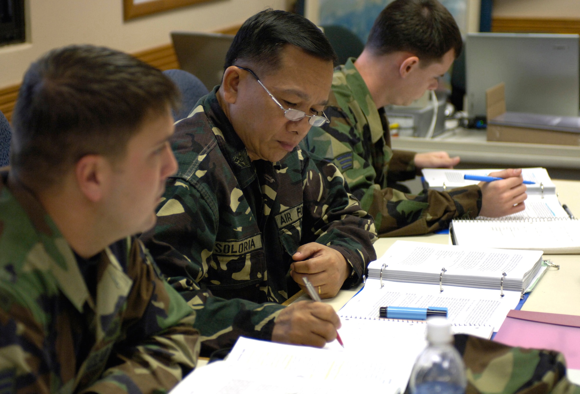HICKAM AIR FORCE BASE, Hawaii -- Command Sgt. Maj. of the Philippine Air Force Cesar Soloria takes notes during Airman Leadership School class, Tuesday, March 7, 2006, at Hickam Air Force Base, Hawaii. The command sergeant major and four other students are the first Philippine Air Force Airmen to attend the class. They will take back the lessons learned and develop their own course within their air force.