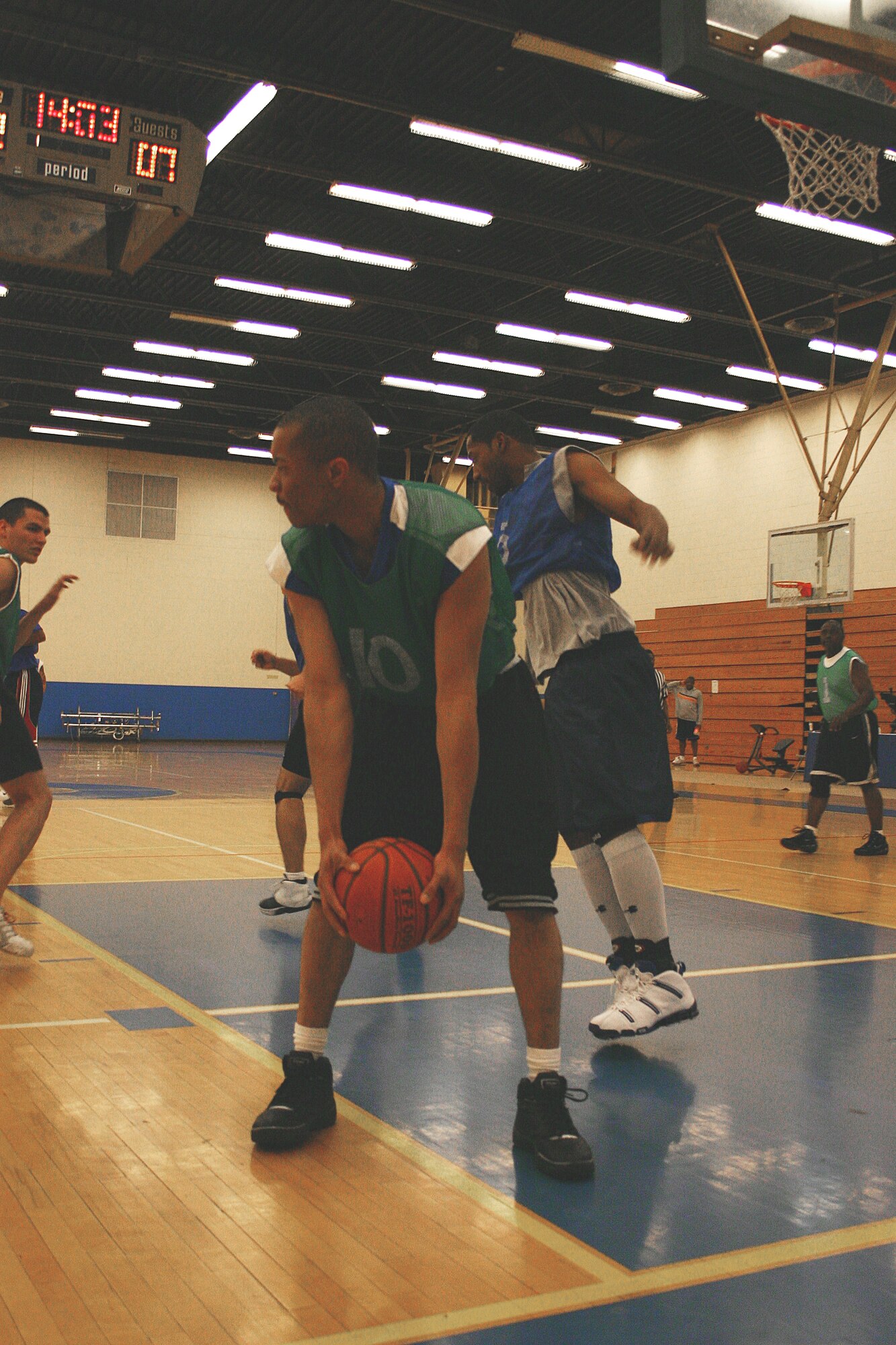 CANNON AIR FORCE BASE, N.M. -- CS' Fumisho Bass snatches the rebound from CES early in the first half. Bass pulled off 14 points to tie as his team's lead scorer. (U.S. Air Force photo by Airman Thomas Trower)