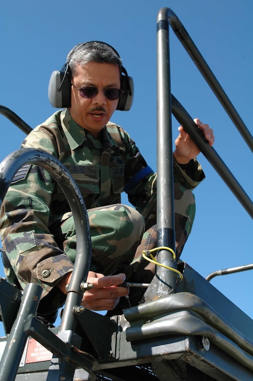 Master Sgt. Edmund Diaz, 60th Aircraft Maintenance Squadron production supervisor, inserts a safety pin on a B5 stand railing. (U.S. Air Force photo by Staff Sgt. Matt McGovern) 