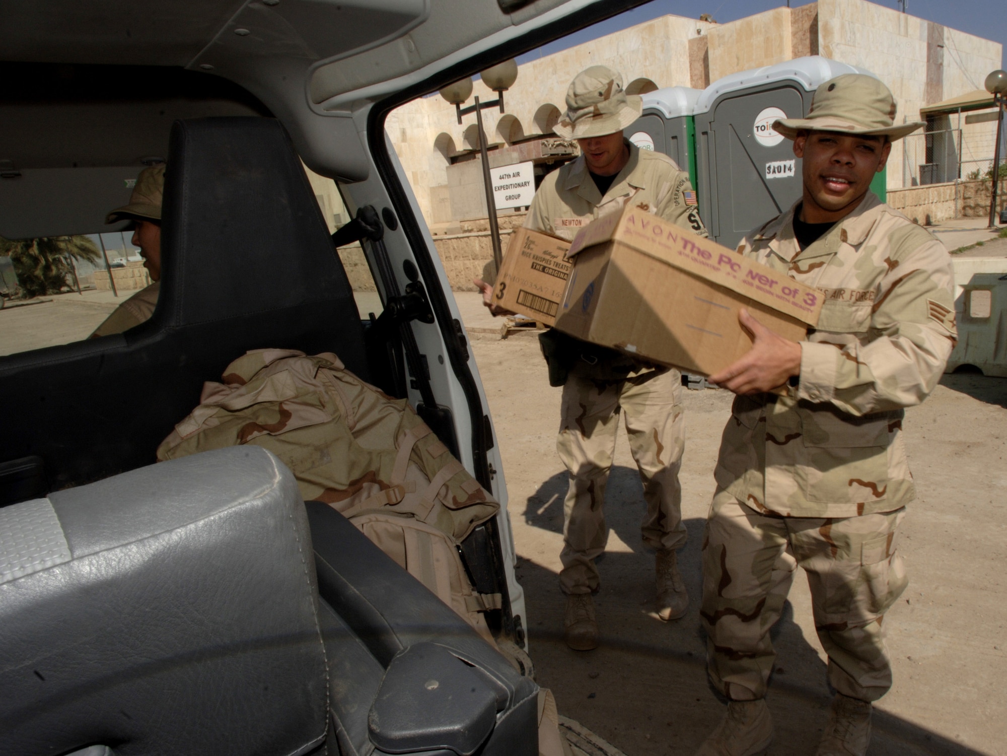 Senior Airman Argenis Sambois carries a box full of toys, candy and school supplies for the children he will see at the Radhwaniya Medical Clinic Outreach Program. Airman Sambois is assigned to the 447th Expeditionary Civil Engineer Squadron at Sather Air Base, Iraq. Several times a week, volunteers meet at the facility on the edge of the Baghdad International Airport, and support the medical needs of civilians. (U.S. Air Force photo/Master Sgt. Lance Cheung)

