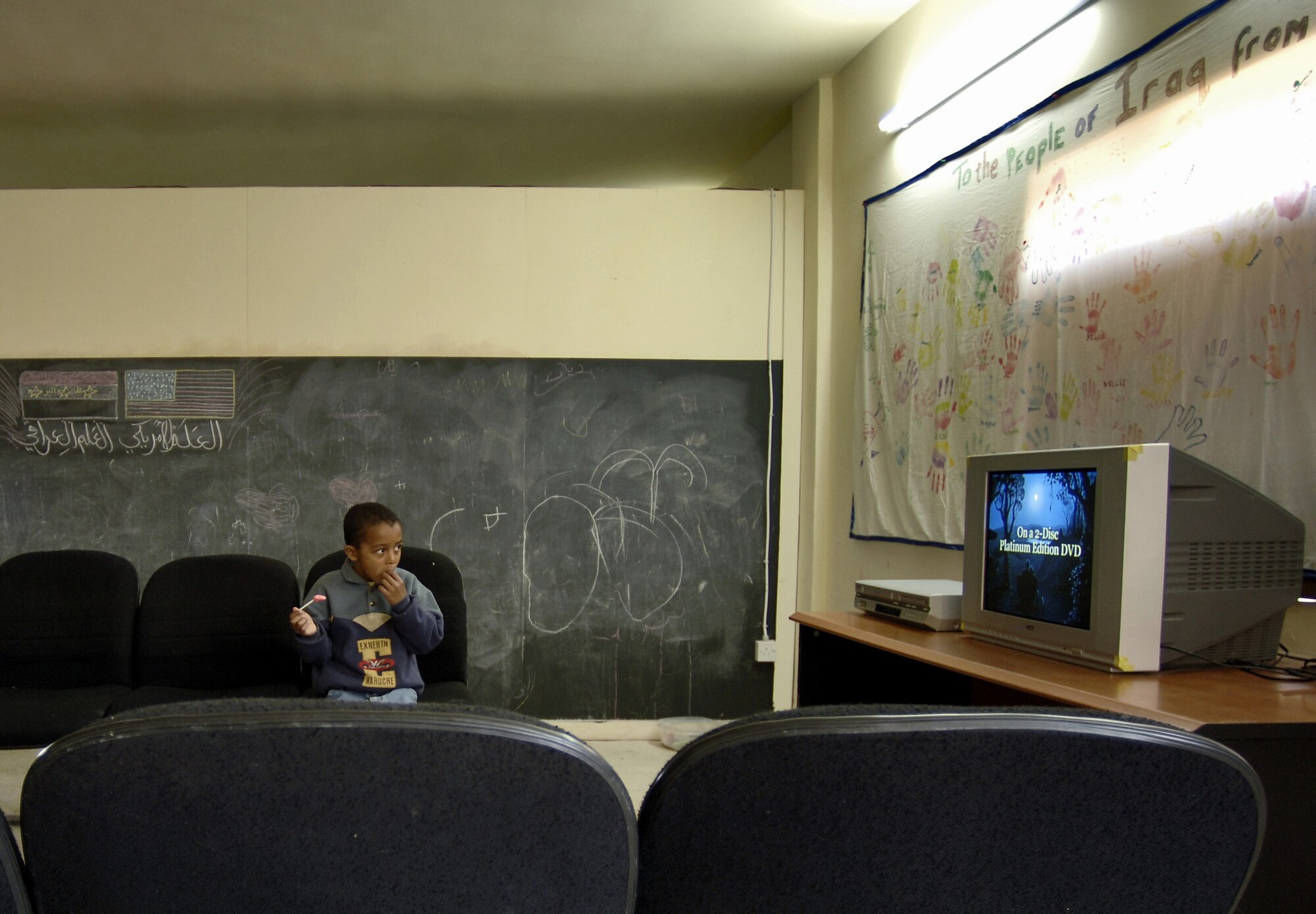 An animated TV program entertains an Iraqi boy while he waits to be seen at the Radhwaniya Medical Clinic Outreach Program. Several times a week volunteers meet at the facility on the edge of the Baghdad International Airport area and support the medical needs of civilians. (U.S. Air Force photo/Master Sgt. Lance Cheung) 