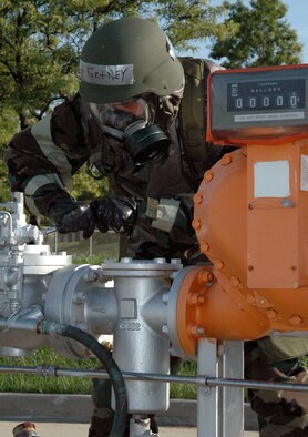 YOUNGSTOWN AIR RESERVE STATION, OHIO - Air Force Reserve Staff Sgt. Martin Fortney, a liqued fuels specialist with the 910th Civil Engineer Squadron here, performs maintenance on an aircraft fuel pumping system as part of Task Qualification Training (TQT).  Sergeant Fortney performed his duties while wearing full chemical protective gear in Mission Oriented Protective Posture Level 4, demonstrating his ability to do his job in a chemically contaminated environment.  (U.S. Air Force photo by Master Sgt. Bryan Ripple)