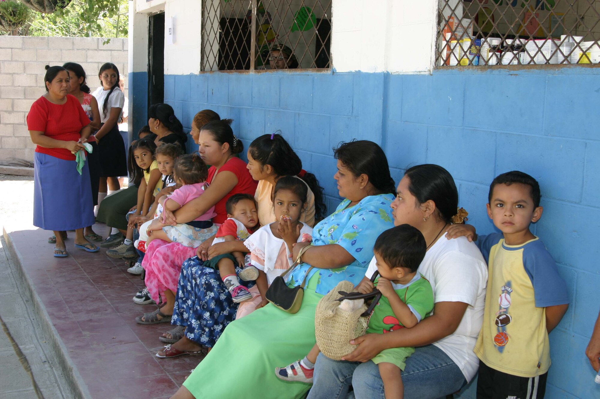 Local El Salvadoran citizens wait in line outside the schoolhouse classroom for their turn to be seen by Air Force Reserve Airmen running the pediatric section.  Those who came for medical care had the option of being seen by pedicatrics, general medicine, optometry, dental or gynocology.