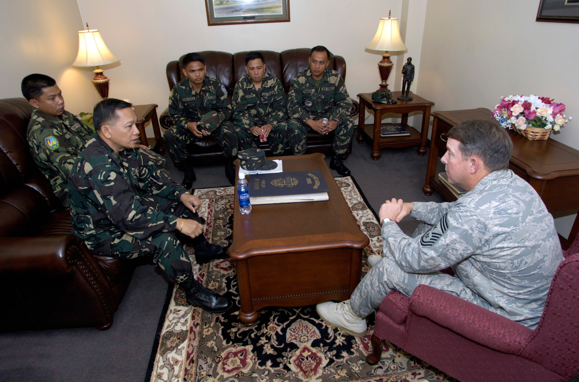 Pacific Air Forces Command Chief Master Sgt. Rodney McKinley talks with Command Sgt. Maj. of the Philippine Air Force Cesar Soloria and other Philippine Air Force students after their Airman Leadership School class Tuesday, March 7, 2006, at Hickam Air Force Base, Hawaii. They are the first Philippine Air Force students to attend the class. They will take back the lessons learned and develop their own leadership course within their air force. (U.S. Air Force photo/Tech. Sgt. Shane A. Cuomo) 