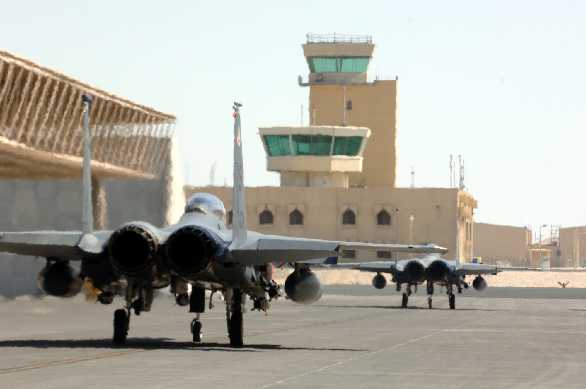 Two F-15E Strike Eagles from the 336th Expeditionary Fighter Squadron taxi for takeoff Wednesday, March 8, 2006, at a deployed location in southwest Asia. The 336th is home-based at Seymour Johnson Air Force Base, N.C. (U.S. Air Force photo/Staff Sgt. Joshua Strang)

