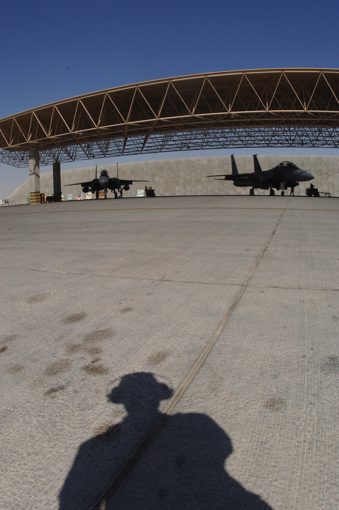 A crewmember watches as two F-15E Strike Eagles from the 336th Expeditionary Fighter Squadron prepare for takeoff Wednesday, March 8, 2006, at a deployed location in Southwest Asia. The 336th is home-based at Seymour Johnson Air Force Base, N.C. (U.S. Air Force photo/Staff Sgt. Joshua Strang)