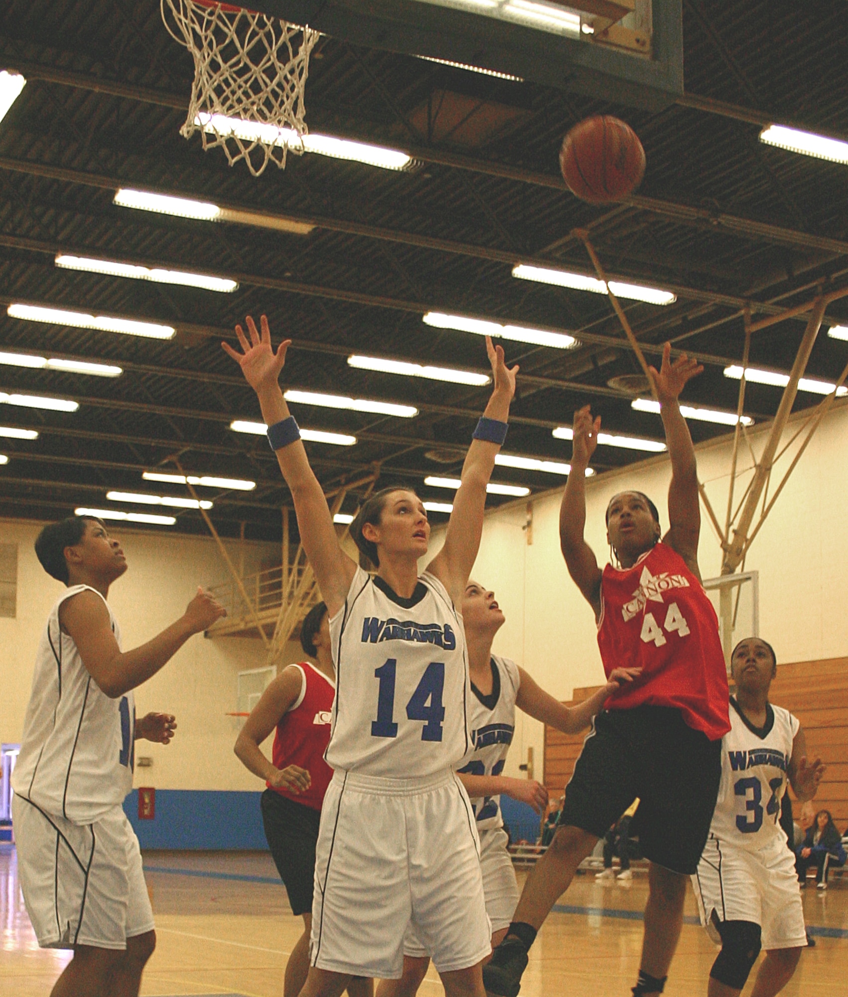 CANNON AIR FORCE BASE, N.M. -- Katrevious Swift (44), Cannon Warriors, goes over Lacey Childers (14), Lackland Warhawks, for two points Sunday. The Warriors downed the Warhawks 66-29. (U.S. Air Force photo by Airman Thomas Trower)