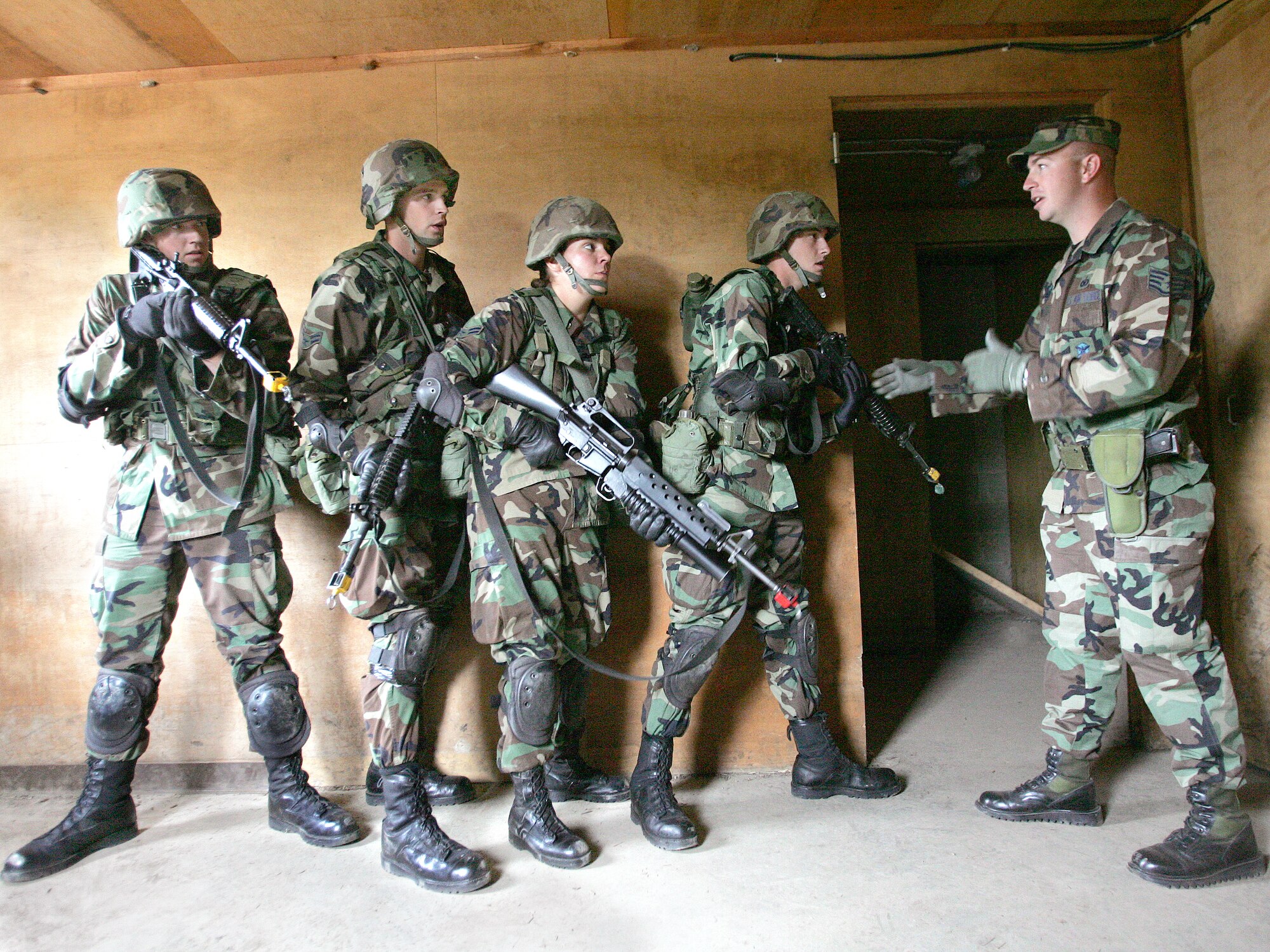 Staff Sgt. Brandon King instructs students on building search and clearing procedures during a training session at Camp Bullis, Texas, Tuesday, March 7, 2006.  Sergeant King is an instructor with the 343rd Training Group at Lackland Air Force Base, Texas. (U.S. Air Force photo/Robbin Cresswell)

                               