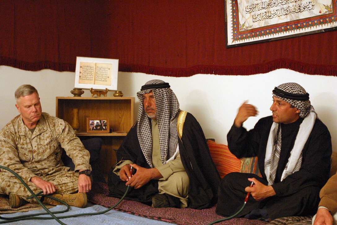 Basim al-Shamary, a native of Al-Kut, Iraq, and a dinner participant speaks with Lt. Gen. James F. Amos, II Marine Expeditionary Force commanding general during a cultural immersion dinner March 10.  The dinner was part of the 24th Marine Expeditionary Unit's Training in an Urban Environment Exercise taking place throughout the Hampton Roads, Va., area.