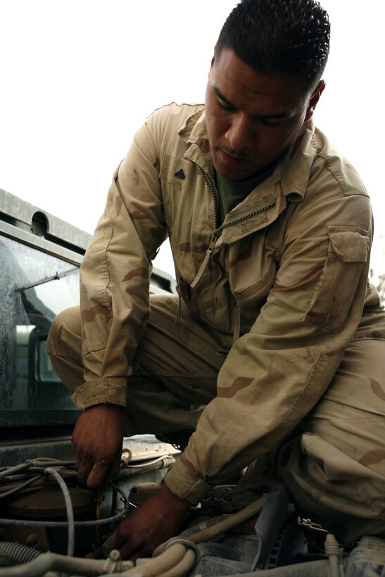 Cpl. George W. Gonzales, a 21-year-old from San Jose, Calif., replaces an emissions control tube on a hummvee. Diesel mechanics like Gonzales perform preventive maintenance to keep trucks operating smoothly on the roads of Iraq and repair vehicles that break from continuous operations.  Everyday in Iraq, the1st Marine Logistics Group sends out combat logistics patrols that leave the relative safety of the base to deliver supplies to Marines throughout the Al Anbar Province.  From the Marines who order and load the supplies onto 7-ton transportation trucks, to the mechanic that keeps the trucks running ? many people play a key role to keep the supply train moving.