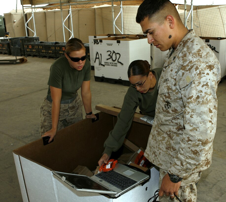 From left to right: Lance Cpl. Crystal M. Balm, 19, from Otho, Iowa; Cpl. Angela M. Villanueva, 20, Trenton, N.J.; and Cpl. Sergio A. Luna, 22, Brownsville, Texas organize supplies that will leave for various bases throughout Iraq. The mission requires the Marines to work with the utmost attention to detail to support anywhere from 400 to 1,200 individual requests for equipment daily. Everyday in Iraq, the1st Marine Logistics Group sends out combat logistics patrols that leave the relative safety of the base to deliver supplies to Marines throughout the Al Anbar Province. From the Marines who order and load the supplies onto 7-ton transportation trucks, to the mechanic that keeps the trucks running ? many people play a key role to keep the supply train moving.