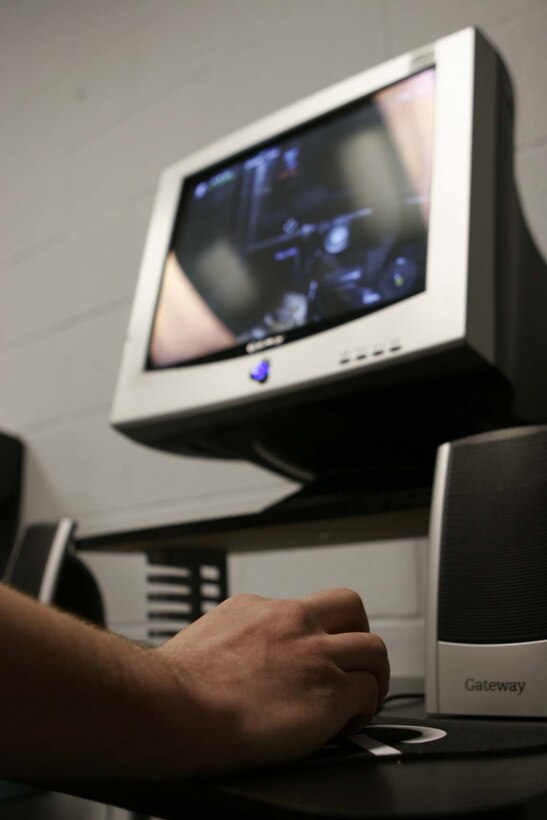 MARINE CORPS BASE CAMP LEJEUNE, N.C. -- A Marine uses the mouse to play the new training game "First to Fight" at the French Creek Recreation Center March 9. The new video game is being used by the Marine Corps to help educate Marines about substance abuse and effects on mission accomplishment.