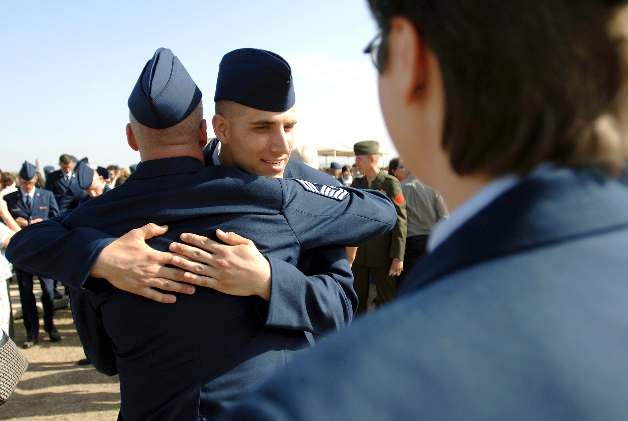 Airman Basic Lance Bowes embraces his father, Chief Master Sgt. Jeff Bowes after graduating from Air Force basic military training course at Lackland Air Force Base, Texas, Friday, March 10, 2006. Airman Bowes was assigned to the 322nd Training Recruit Squadron Flight 235. Chief Bowes is the 14th Flying Training Wing command chief at Columbus Air Force Base, Miss. (U.S. Air Force photo/Tech. Sgt. Cecilio Ricardo) 