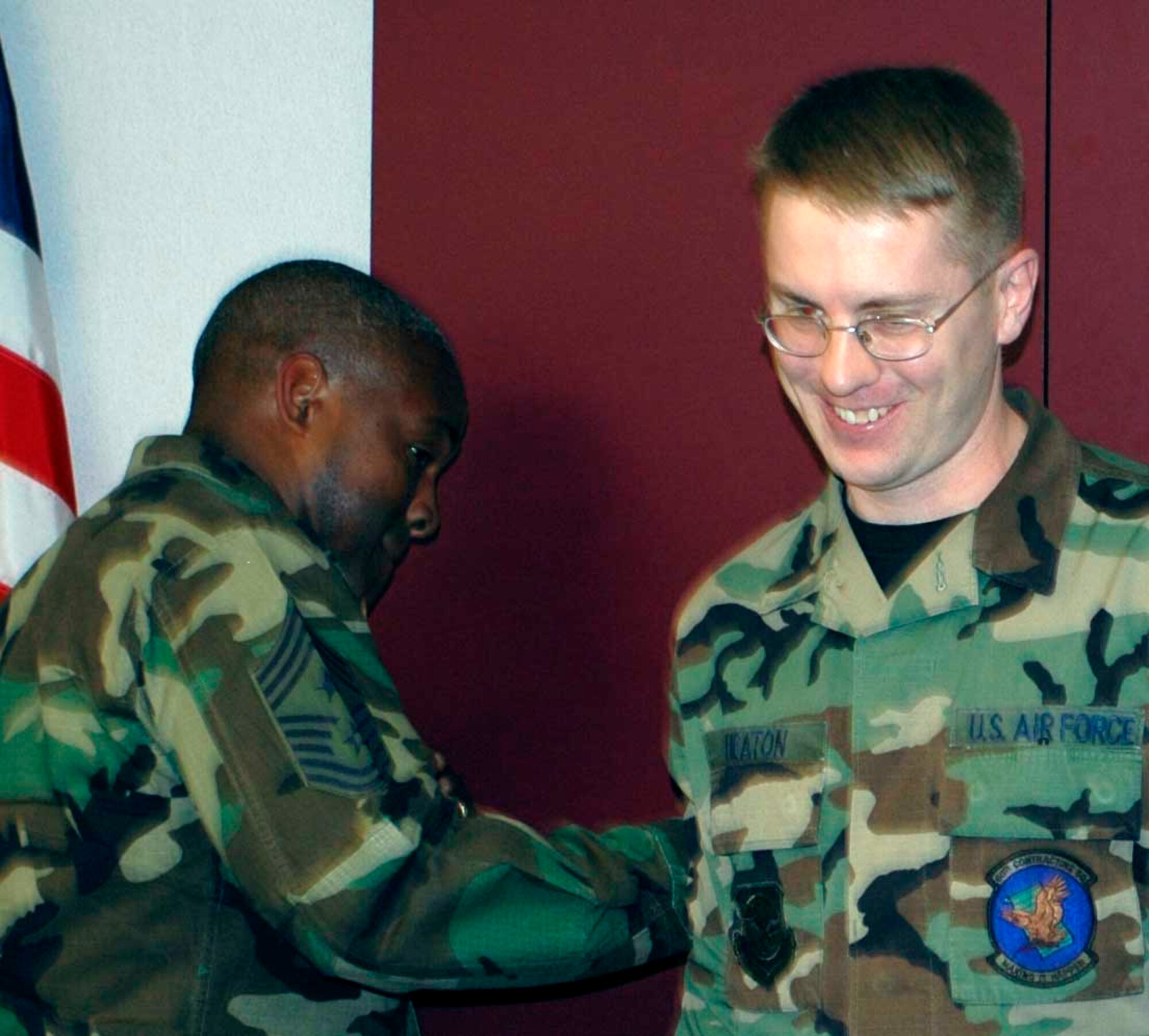 Master Sgt. Eric Heaton, 60th Contracting Squadron team lead contracting officer, received his new stripes from Chief Master Sgt. Brye McMillon, 60th Air Mobility Wing command chief, March 2. (U.S. Air Force photo by Staff Sgt. Candy Knight)