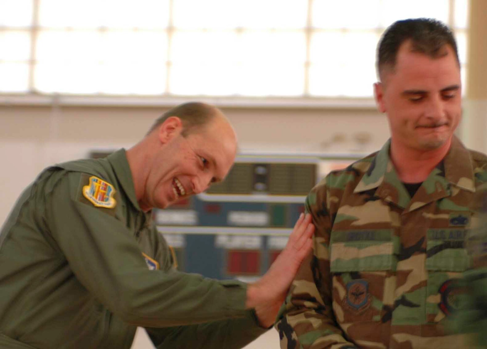 Master Sgt. Paul Grotke, 660th Aircraft Maintenance Squadron mobility readiness section NCO in charge received his promotion stripes from Col. Timothy Zadalis, 60th Air Mobility Wing acting commander, March 2. (U.S. Air Force photo by Staff Sgt. Matt McGovern)
