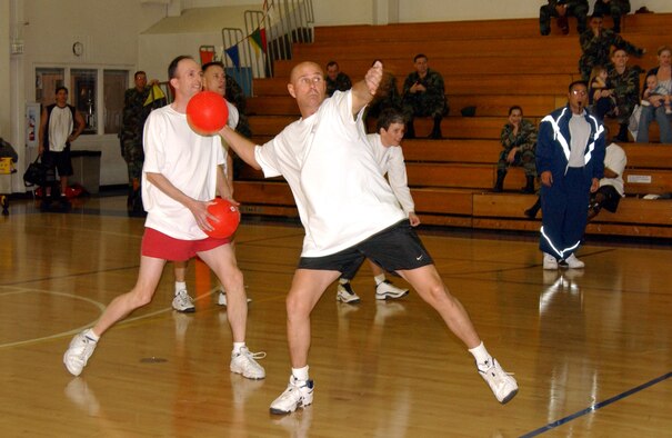 Col. Tracy Hardwick winds up for a throw against the Chiefs team while Col. Al Carney [left] looks for a target during the dodge ball match at the fitness center March 2. (U.S. Air Force photo by Nan Wylie)