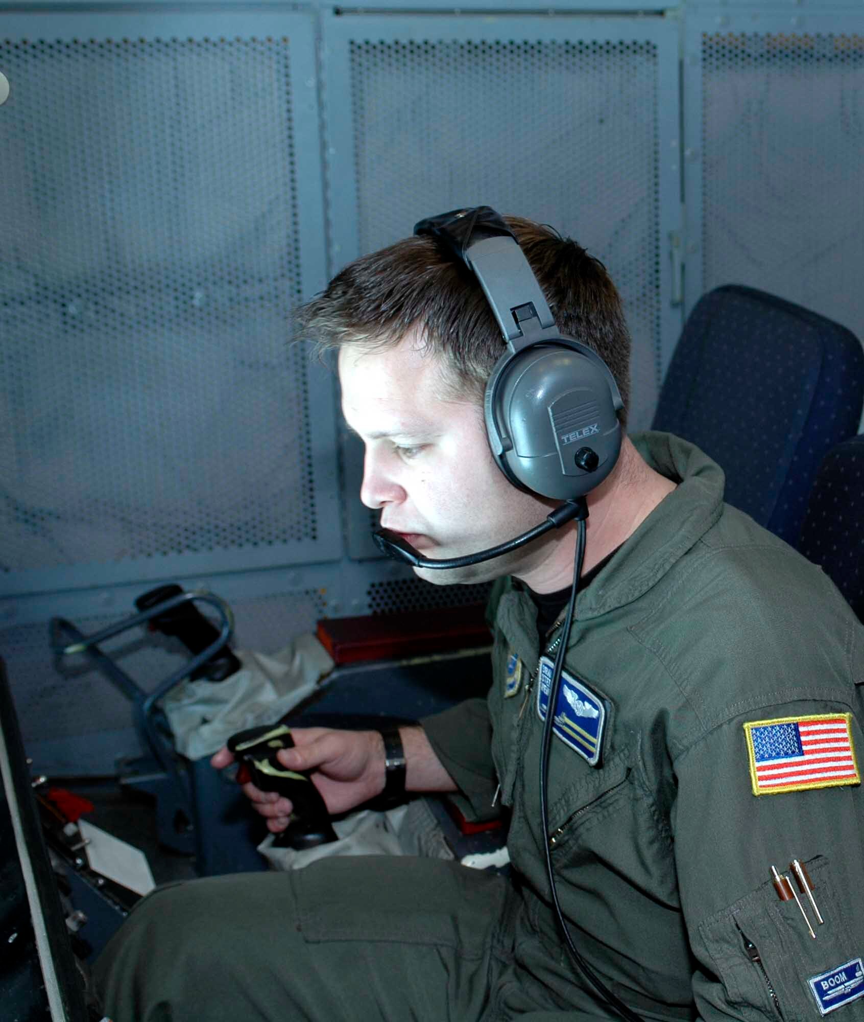 Senior Airman Stephen Wentz, 6th Air Refueling Squadron in-flight refueler, checks the position of a B-1 Bomber during a refueling mission. Boom operators must operate in-flight air refueling controls while maintaining a safe and affective contact between tanker and receiver aircraft. (U.S. Air Force photo by Staff Sgt. Candy Knight)
