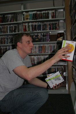 INCIRLIK AIR BASE, Turkey (USAFENS) -- Airman 1st Class Alex Griffin, Air Force News Det. 7 broadcaster, organizes movies at the base library. The library is one of the many volunteer opportunities available at Incirlik. (Photo by Senior Airman Tim Beckham)