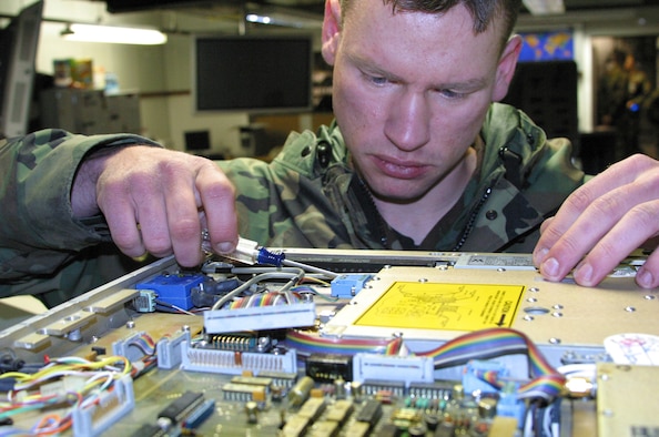 ROYAL AIR FORCE CROUGHTON, England (USAFENS) -- Staff Sgt. Doug Styers, 422nd Communications Squadron Satellite Communications crew chief, troubleshoots the IF Assembly in an Upconverter for the Air Force's first NATO satellite contoller mission. (Photo by Staff Sgt. Chris Stagner)