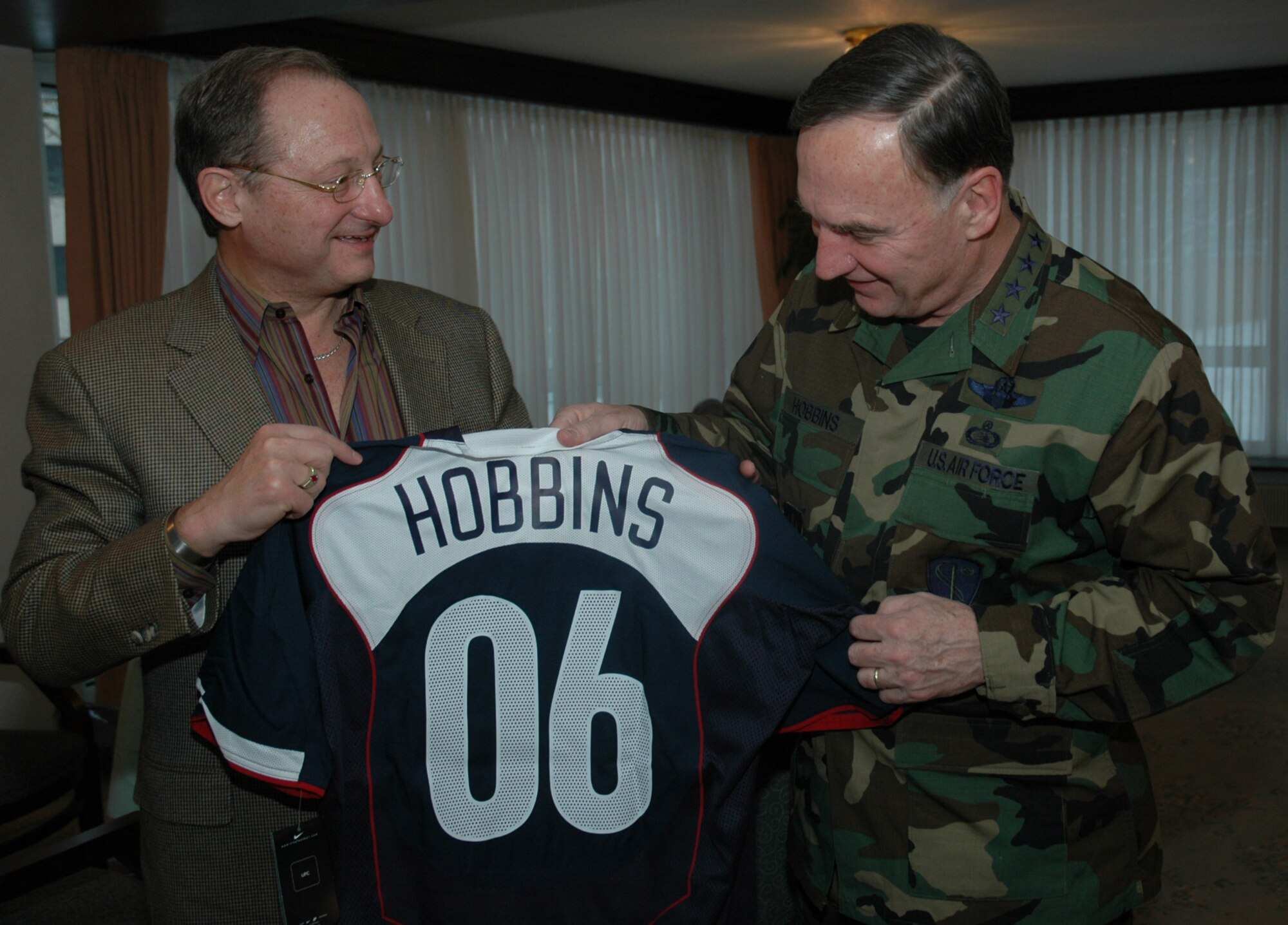 RAMSTEIN AIR BASE, Germany (USAFENS) -- Dr. S. Robert Contiguglia, President of the U.S. Soccer Federation (left), presents Gen. Tom Hobbins, U.S. Air Forces in Europe commander, with an honorary team jersey here Feb. 28. The U.S. Men’s Soccer Team is staying on base prior to playing against Poland Mar. 1. (Photo by 1st Lt. Elizabeth Culbertson)