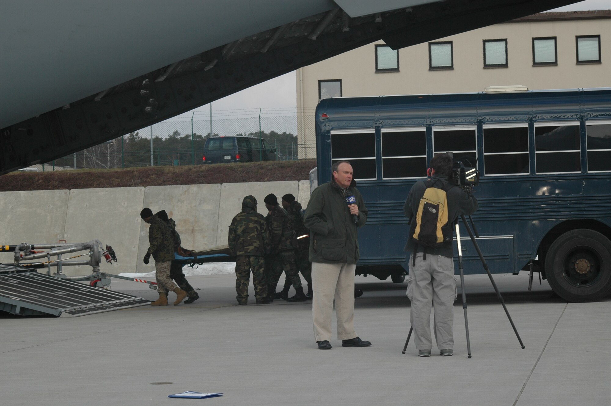 WCBD-TV (News Channel 2) Anchor Warren Peper and Photojournalist, Jonah Jabbour cover members of the 315th Aeromedical Evacuation Squadron as they load patients aboard a C-17 Globemaster III.  WCBD accompanied the 315th Airlift Wing on a trip to feature deployed members of the wing.  (Photo by 1st Lt Wayne Capps, USAFR)
