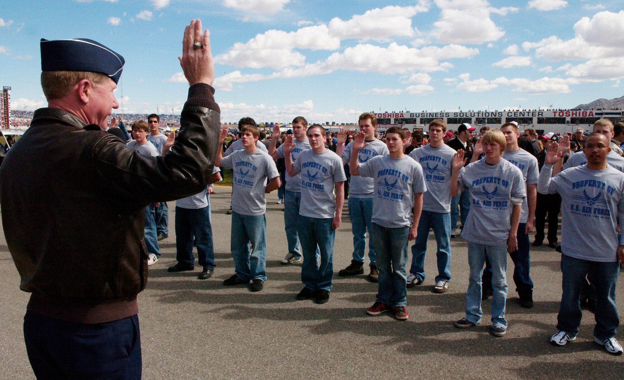 Brig. Gen. Robertus Remkes, Air Force Recruiting Service commander, Randolph Air Force Base, Texas, delivers an oath of enlistment to 24 Air Force delayed entry program members prior to the start of the UAW-Daimler Chrysler 400 Nextel Cup race, Sunday, March 12, 2006, held at the Las Vegas Motor Speedway. (U.S. Air Force photo/Master Sgt. Kevin J. Gruenwald)