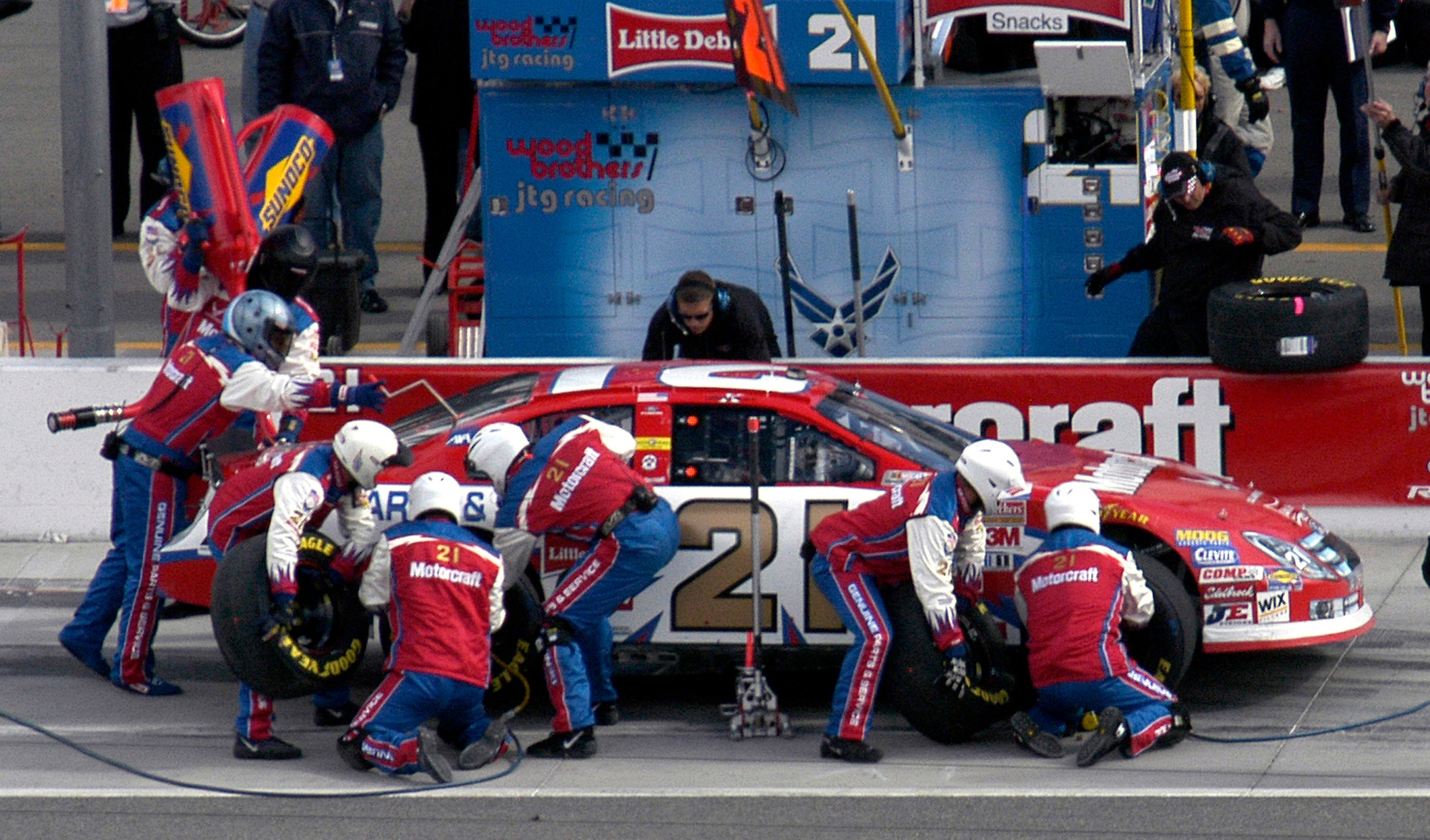 The U.S. Air Force #21 Motorcraft race car driven by Ken Schrader stops for a pit stop to get four new tires and a tank of gas during the UAW Daimler Chrysler 400 race at Las Vegas, Nev., Sunday, March 12, 2006. The car ended the day with engine problems on lap 187, and finished in 41st place. (U.S. Air Force photo/Staff Sgt. Chrissy FitzGerald)                           
                      

                             