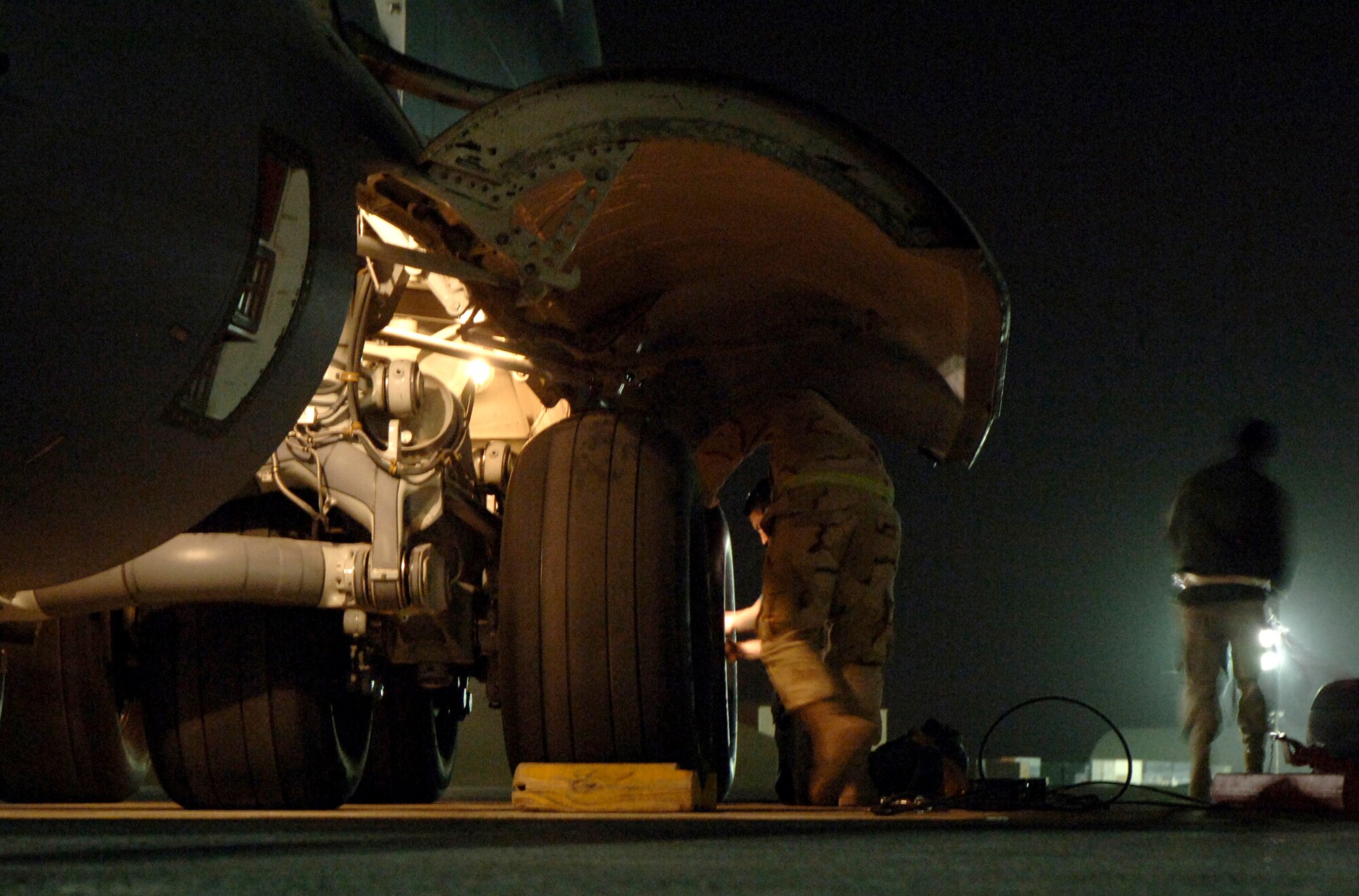 Crewmembers from the 817th Expeditionary Airlift Squadron change a tire on a C-17 Globemaster III at a deployed location in Southwest Asia on Sunday, Mar. 12, 2006. The aircraft is from McChord Air Force Base, Wash. (U.S. Air Force photo/Staff Sgt. Joshua Strang) 