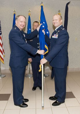SCHRIEVER AIR FORCE BASE, Colo. -- Lt. Gen. Frank Klotz, Vice Commander, Air Force Space Command, presents the new flag for the renamed Space Innovation and Development Center to its commander, Col. Larry Chodzko. The center was formerly called the Space Warfare Center. 