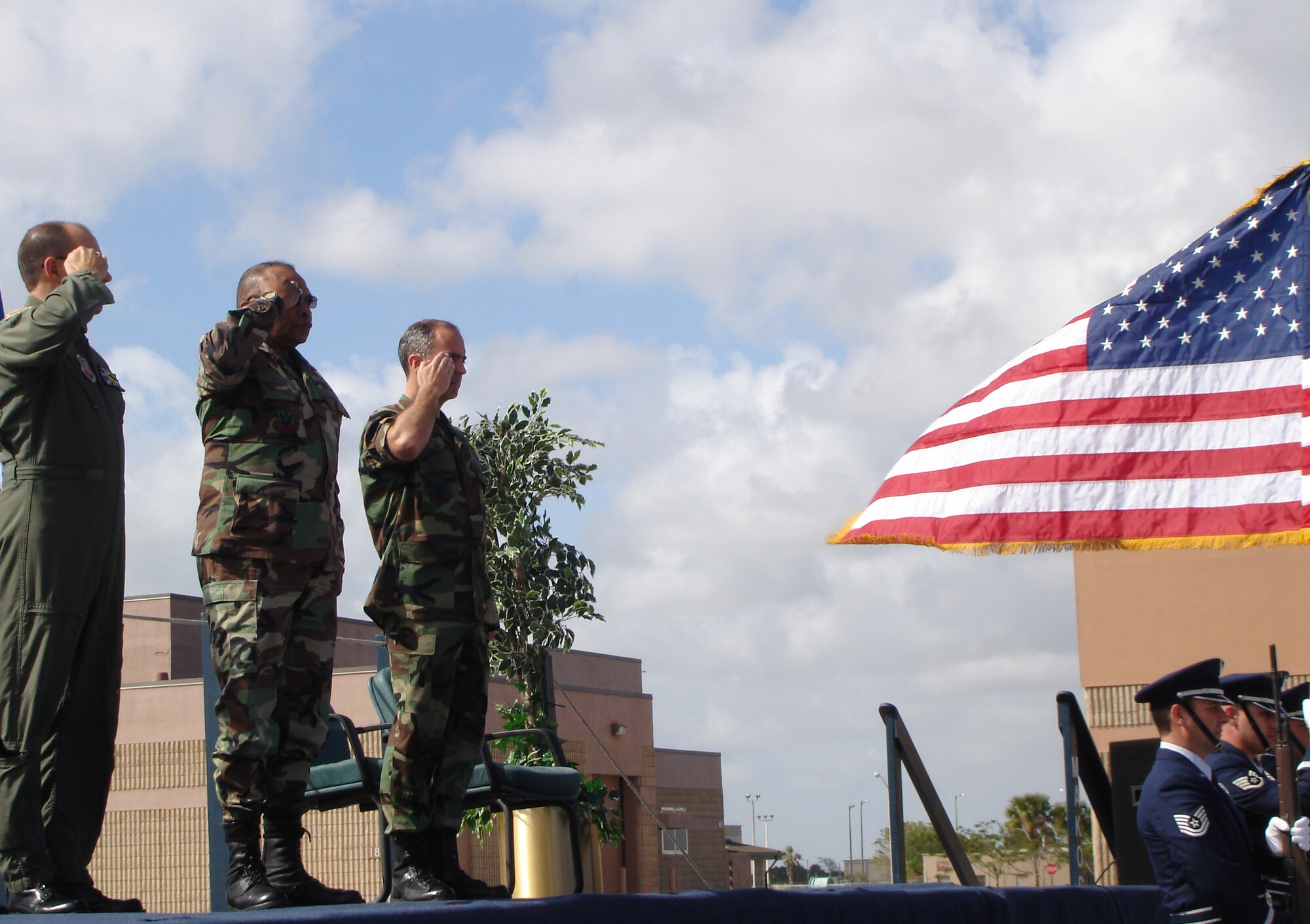 482nd Fighter Wing Commander Col. Randall G. Falcon (left), Col. Herb Brown, and 482nd Maintenance Group Commander Col. T. Glenn Davis present arms during the national anthem at a change of command ceremony on March 11.  During the ceremony Col. Brown relinquished command to Col. Davis after commanding the Homestead ARB maintainers for six years (U.S. Air Force Reserve photo by Jake Shaw).