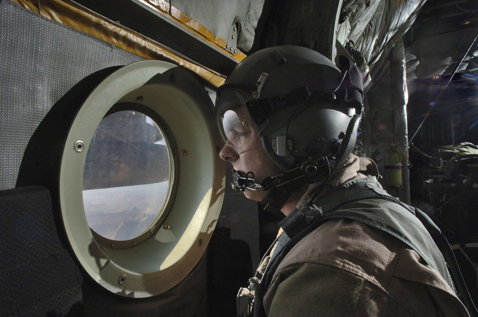 Master Sgt. Bruce Leehan observes the mountainous terrain he will be flying over from Bagram Air Base, Afghanistan, to get to drop zones miles from the Pakistan border Thursday, March 9, 2006.  Sergeant Leehan is from the Oklahoma Air National Guard's 185th Airlift Squadron at the Will Rogers World Airport, Okla. and deployed to the 774th Expeditionary Airlift Squadron, Bagram Air Base, Afghanistan.  (U.S. Air Force photo/Master Sgt. Lance Cheung)