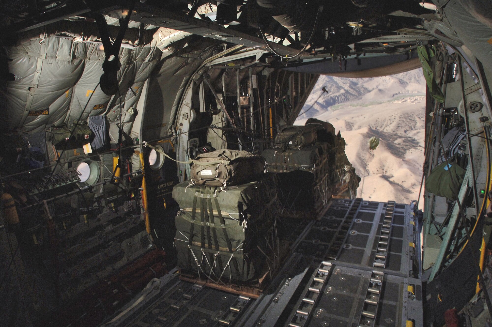 Bundles weighing 2,200 pounds each roll out of a C-130 Hercules during an operational airdrop re-supply mission to deliver 24,000 pounds of supplies to three forward operating bases miles from the Pakistan border Thursday, March 9, 2006.  The aircraft is from the Oklahoma Air National Guard's 185th Airlift Squadron at the Will Rogers World Airport, Okla. and deployed to the 774th Expeditionary Airlift Squadron, Bagram Air Base, Afghanistan.  (U.S. Air Force photo/Master Sgt. Lance Cheung)