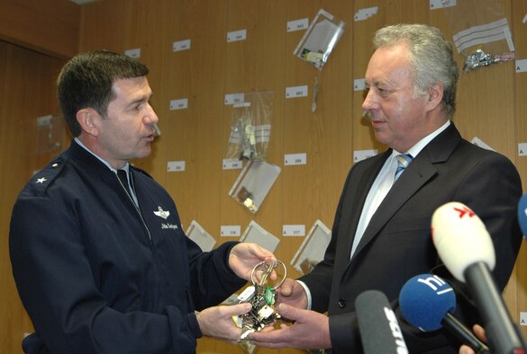 RHEIN-MAIN AIR BASE, Germany (USAFENS) -- Brig. Gen. Mike Snodgrass, U.S. Air Forces in Europe Director of Plans and Programs, hands the keys of the base to Prof. Manfred Schölch, Frankfurt International Airport executive board vice chairman, here Dec. 30 as the last official function of the U.S. air base. After 60 years as the Gateway to Europe, the base will be officially handed back to the Federal Republic of Germany midnight of Dec. 31.  (Photo by Capt. Jonathan Friedman)