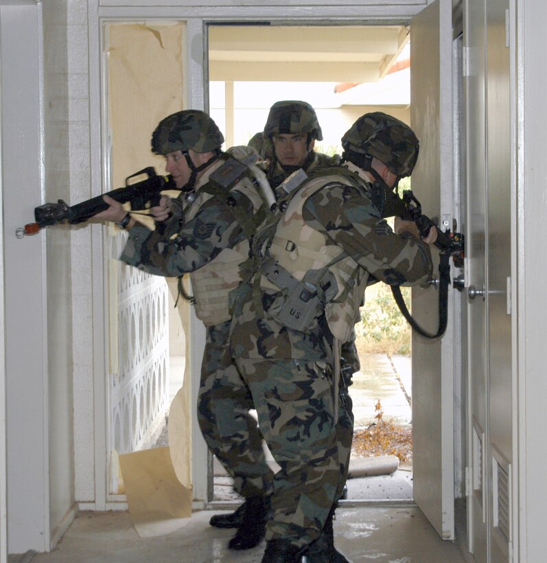 Members of the 944th Security Forces Squadron clear a building in base housing during a search exercise March 11. The 944th SFS practiced tactics to ensure security forces Airmen are prepared for real-world security missions. (U.S. Air Force Reserve photo by Tech. Sgt. Barbara Plante)