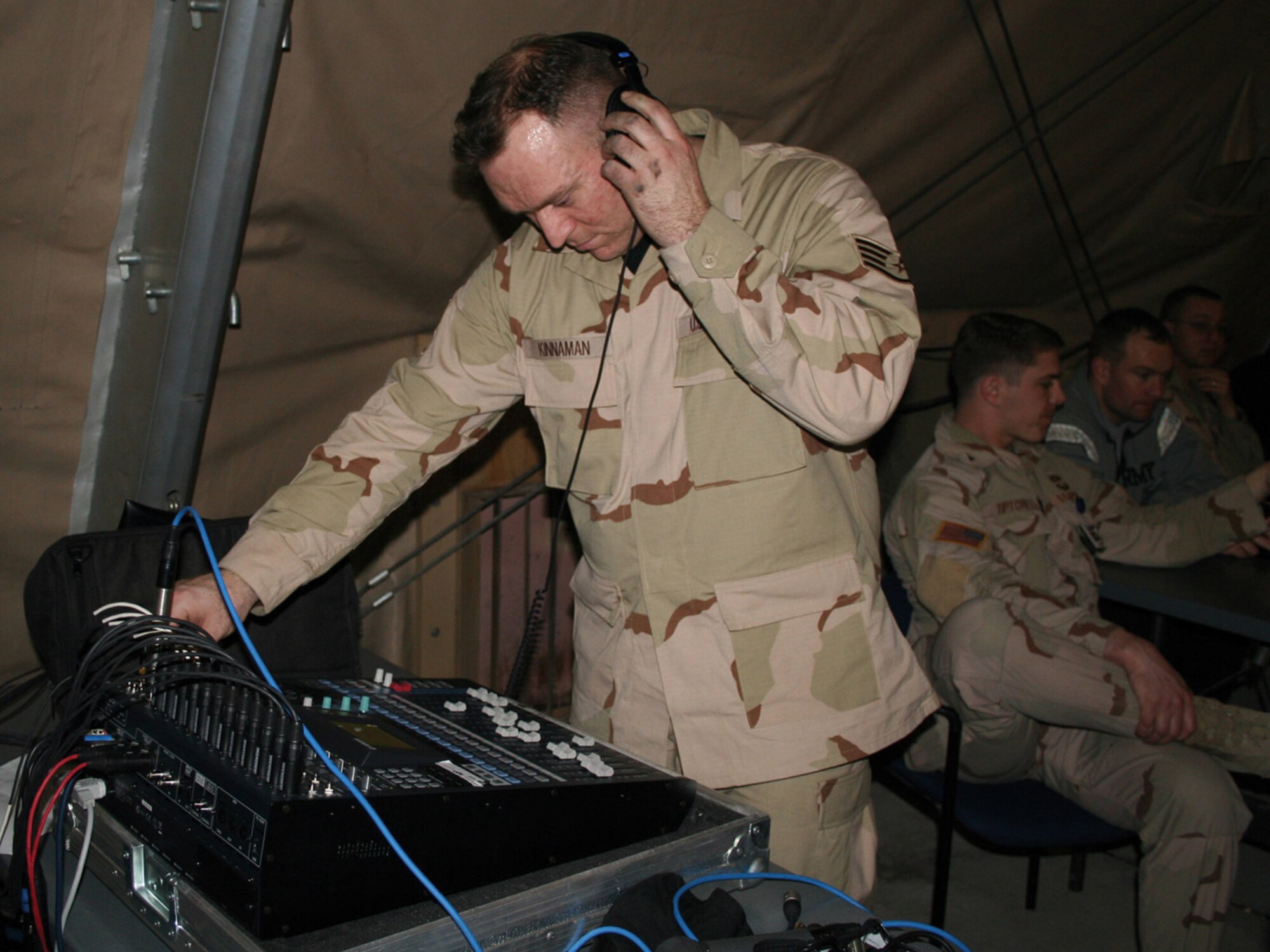 MANAS AIR BASE, KYRGYZSTAN (USAFENS) -- Staff Sgt. Brian Kinnamen, U.S. Air Forces in Europe band, works the sound board at the Direct Hit performance here Feb. 8. (U.S. Air Force photo by Capt. James Bressendorff)