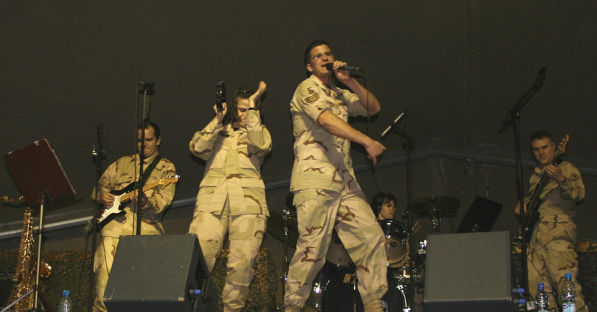 MANAS AIR BASE, KYRGYZSTAN (USAFENS) -- (From left) Senior Airman Ryan Manzi, Tech. Sgt. Kimberley Lively, Staff Sgt. Craig Bowman, Tech. Sgt. Rebecca Taylor and Staff Sgt. Douglas Bennett, members of U.S. Air Forces in Europe band Direct Hit, performed to a packed house here Feb. 8. (U.S. Air Force photo by Capt. James Bressendorff)