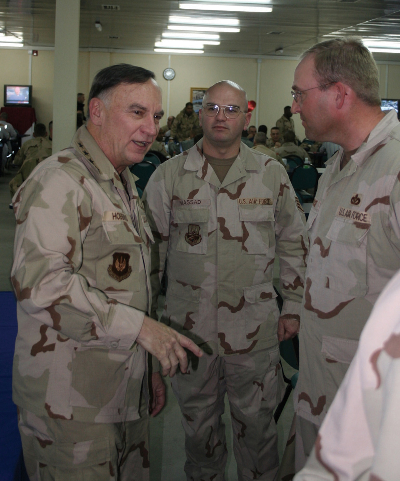 MANAS AIR BASE, KYRGYZSTAN (USAFENS) -- Gen. Tom Hobbins, U.S. Air Forces in Europe commander, speaks to deployed USAFE members Staff Sgt. John Massad Jr. and Chief Master Sgt. Ronald Kruse, 376 Air Expeditionary Wing Civil Engineer Squadron, at the dining facility here Feb. 8. (U.S. Air Force photo by Capt. James Bressendorff)