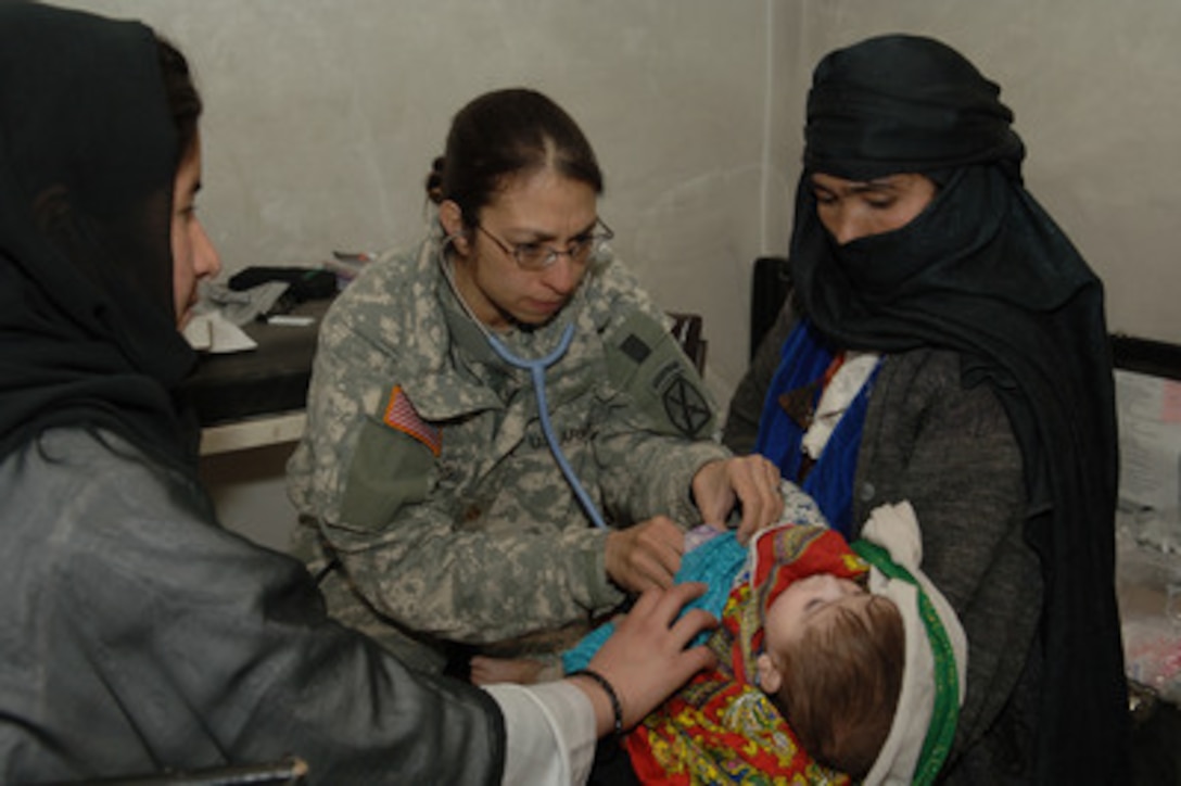 Army Maj. Michelle Flores uses a stethoscope to listen to the breathing and lung function of an Afghan child during a medical civic assistance program in Nayak, Afghanistan, on March 2, 2006. Flores is attached to the U.S. Armyís 10th Mountain Infantry Division. 