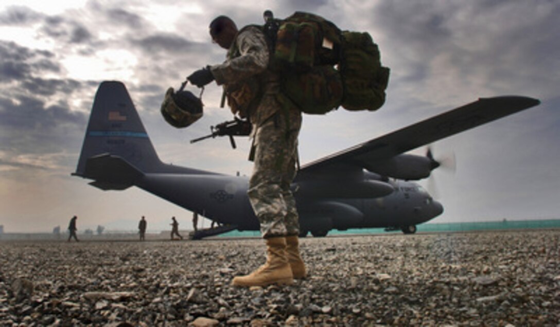 U.S. Army Sgt. 1st Class Ricky Bryant is last in line to board a C-130H2 Hercules aircraft at Bagram Air Base, Afghanistan, for a flight to Forward Operations Base Salearno, Afghanistan, on March 8, 2006. The aircraft and crew are assigned to the 185th Airlift Squadron, Will Rogers World Airport, Oklahoma Air National Guard and are deployed to the 774th Expeditionary Airlift Squadron, Bagram Air Base. 