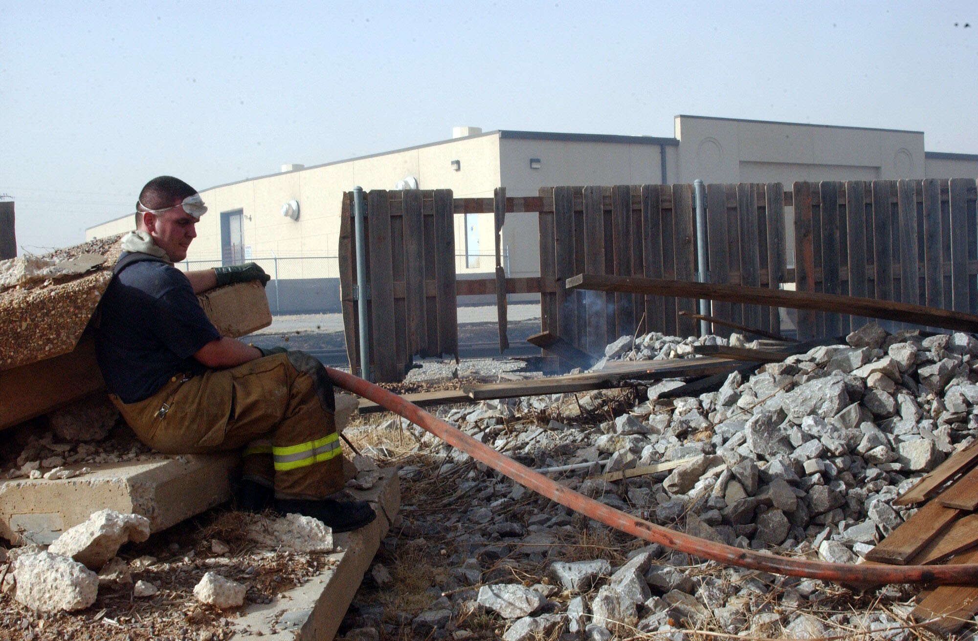 Firefighter Airman 1st Class Thomas Mix from Altus Air Force Base, Okla., takes a break from fighting a fire on base Sunday, March 12. The blaze consumed more than 100 acres near the base's south entrance gate. (Courtesy photo) 
