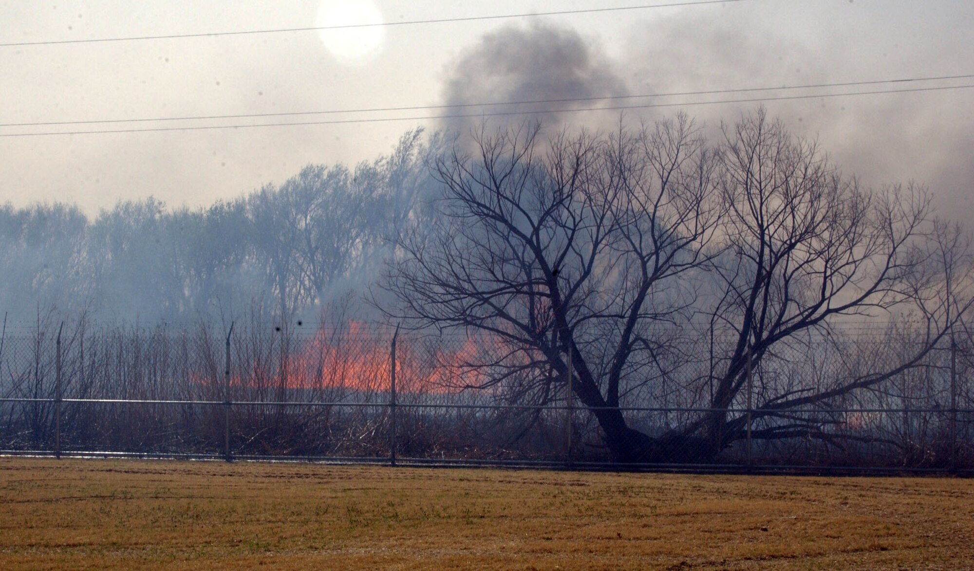 A fire burns outside the south entrance gate of Altus Air Force Base, Okla. Sunday, March 12. The fire eventually made its way on base. No injuries were reported. (Courtesy photo) 
