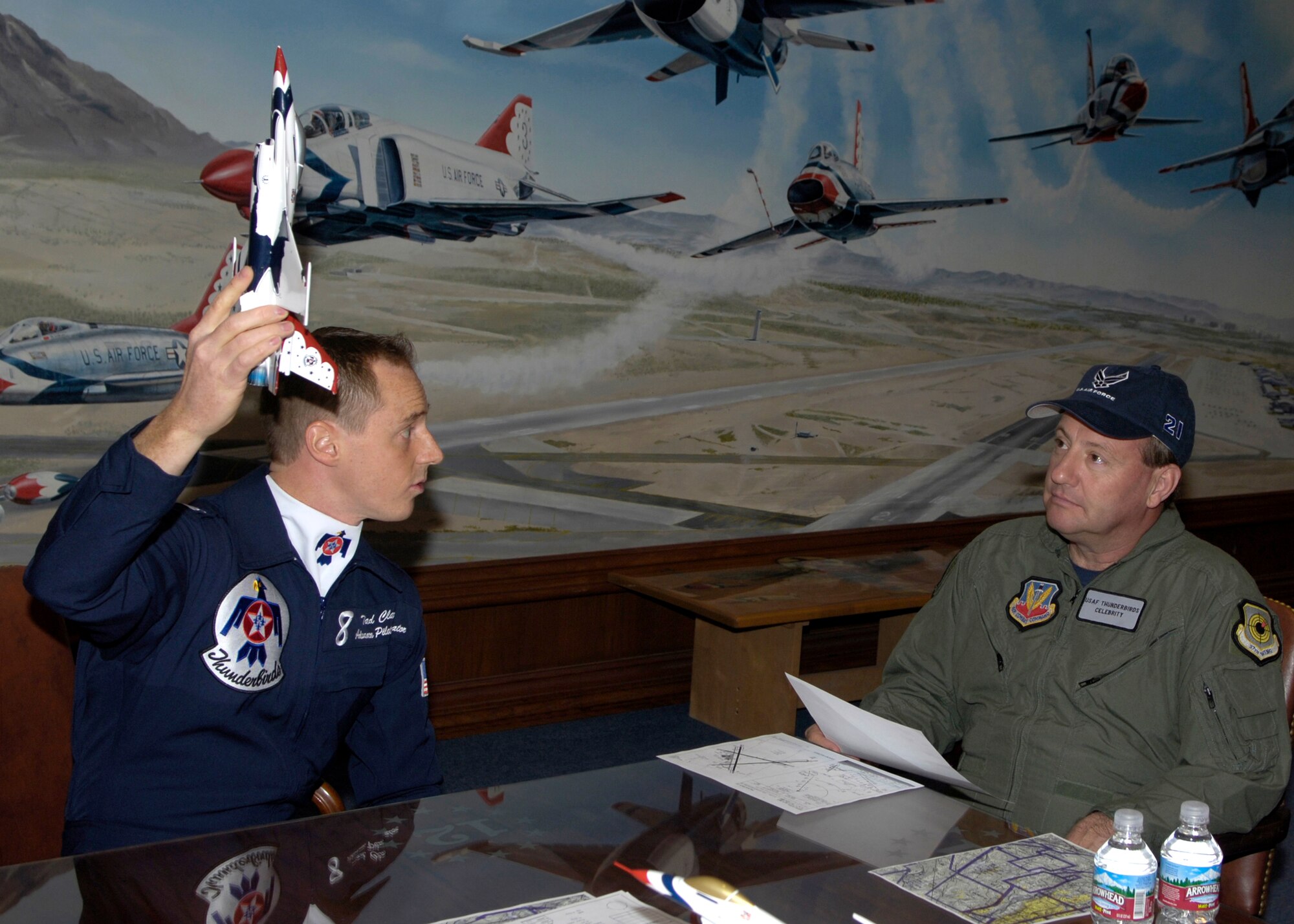 Capt. Tad Clark shows Kenny Schrader, driver of the Air Force #21 Wood Brothers/JTG Racing Ford Fusion how they are going to climb after take off, Thursday, Mar. 9, 2006.  Mr. Schrader received an orientation flight with the Air Force Thunderbirds. Captain Clark is an advance pilot/narrator for the Thunderbirds. (U.S. Air Force photo/Larry McTighe) 