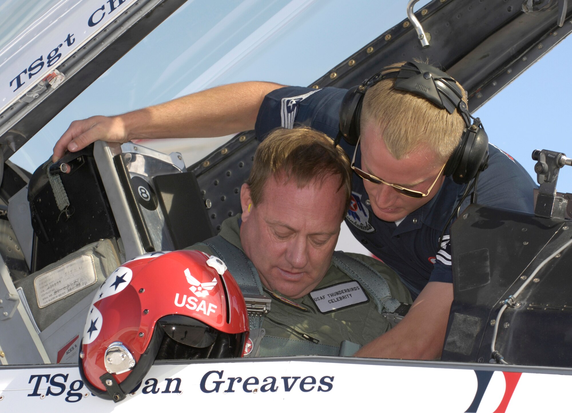 Kenny Schrader, driver of the Air Force #21 Wood Brothers/JTG Racing Ford Fusion receives help getting strapped into an F-16 Fighting Falcon Thunderbird for an orientation flight on Thursday, Mar. 9, 2006. (U.S. Air Force photo/Larry McTighe)