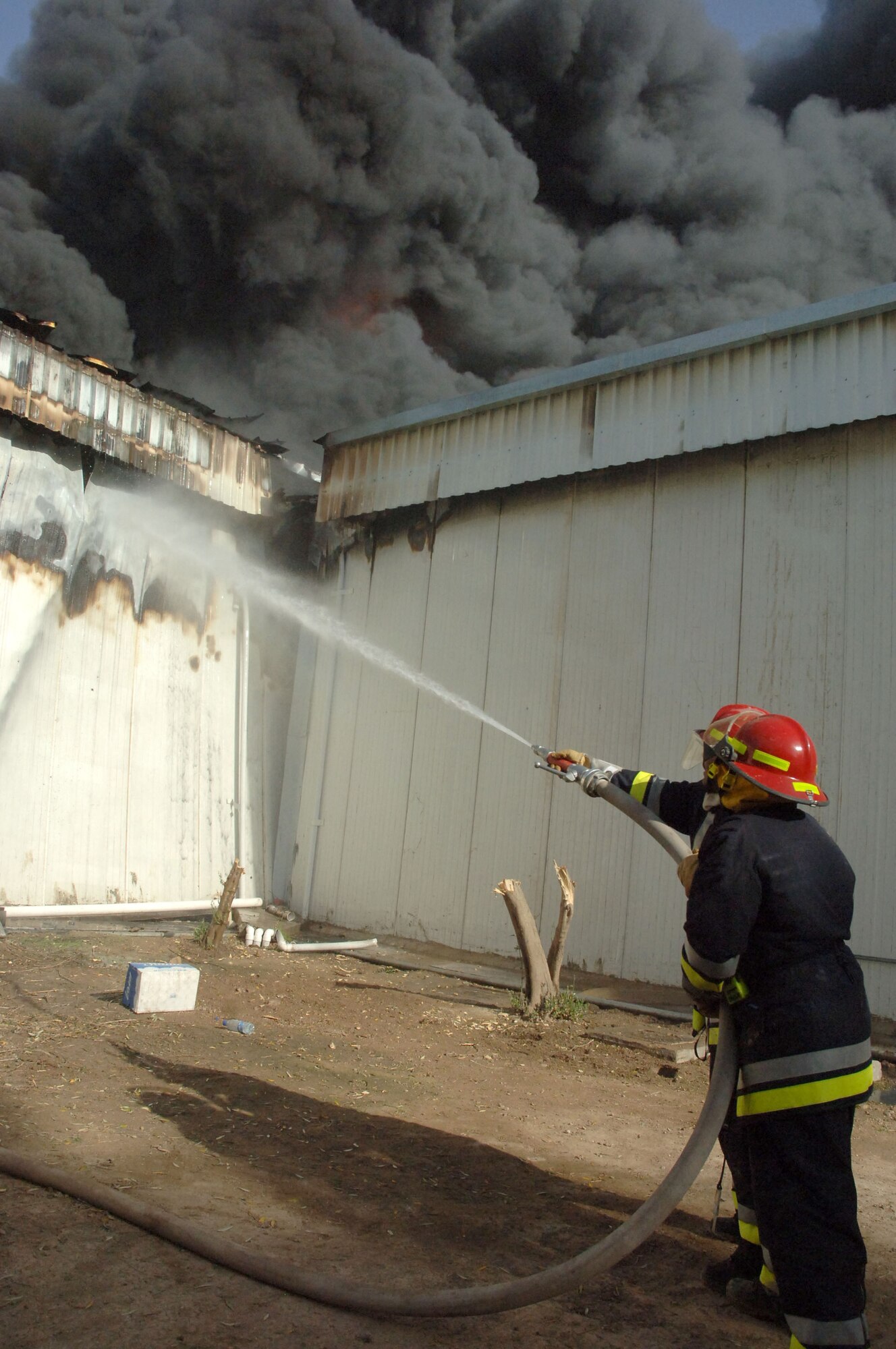 Iraqi firefighters battle a five-alarm blaze at a weapons training facility at Victory Base Complex, Iraq, March 11, 2006. U.S. and Iraqi firefighters saved half of the facility, including an indoor firing range.  (U.S. Air Force photo/Master Sgt. Will Ackerman)