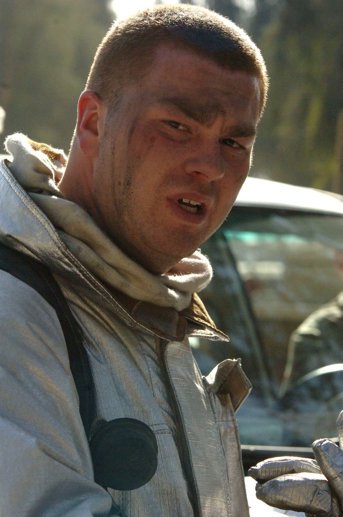 Staff Sgt. Adam Thurston takes a break after fighting a fire at a weapons training facility March 11, 2006, at Victory Base Complex, Iraq. American and Iraqi firefighters from five stations battled the blaze at the facility. He is with the 447th Expeditionary Civil Engineer Squadron Fire Department. (U.S. Air Force photo/Master Sgt. Will Ackerman)
