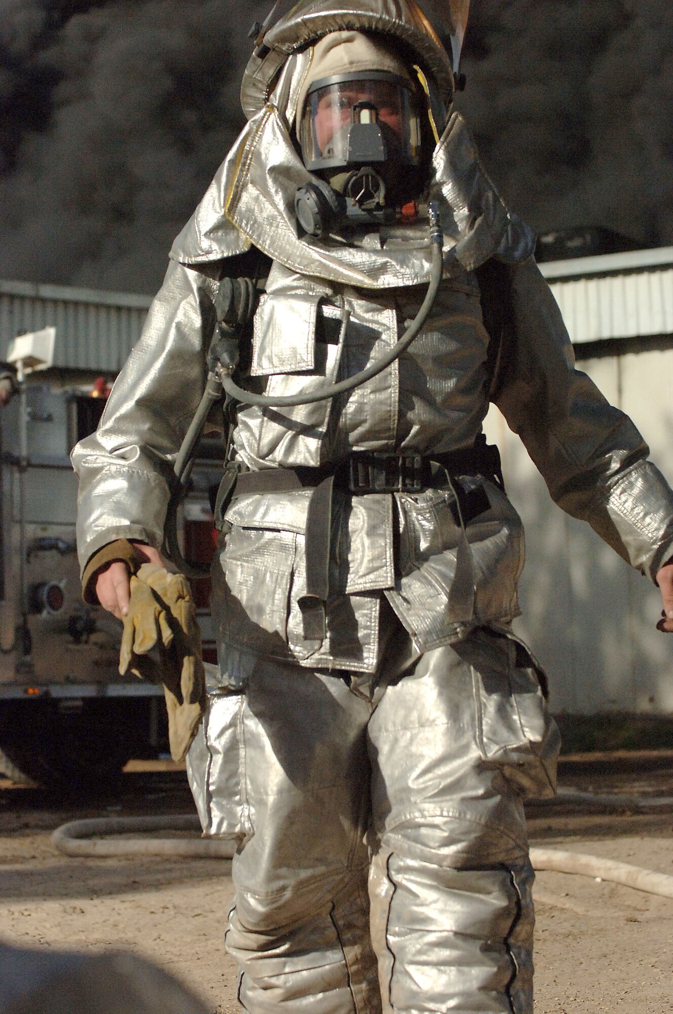A firefighter from the 447th Expeditionary Civil Engineer Squadron fire department prepares to battle a fire at a weapons training facility March 11, 2006, at Victory Base Complex, Iraq. Iraqi and American firefighters from five stations battled the blaze at the facility. (U.S. Air Force photo/Master Sgt. Will Ackerman)