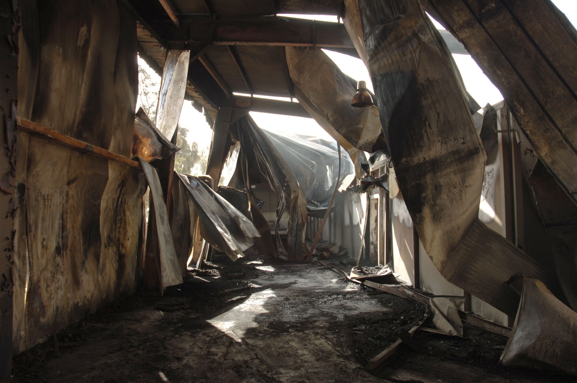 Fire destroyed half of a weapons training facility at Victory Base Complex, Iraq, March 11. American firefighters from Sather Air Base, Camps Victory and Liberty joined Iraqi firefighters from the training facility and Baghdad International Airport to battle the blaze. (U.S. Air Force photo/Master Sgt. Will Ackerman)